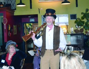 Olympic Steam director Nathan Barnett talks about the upcoming steampunk festival at a Main Street breakfast on Wednesday as Debi Goetz listens.  Charlie Bermant/Peninsula Daily News