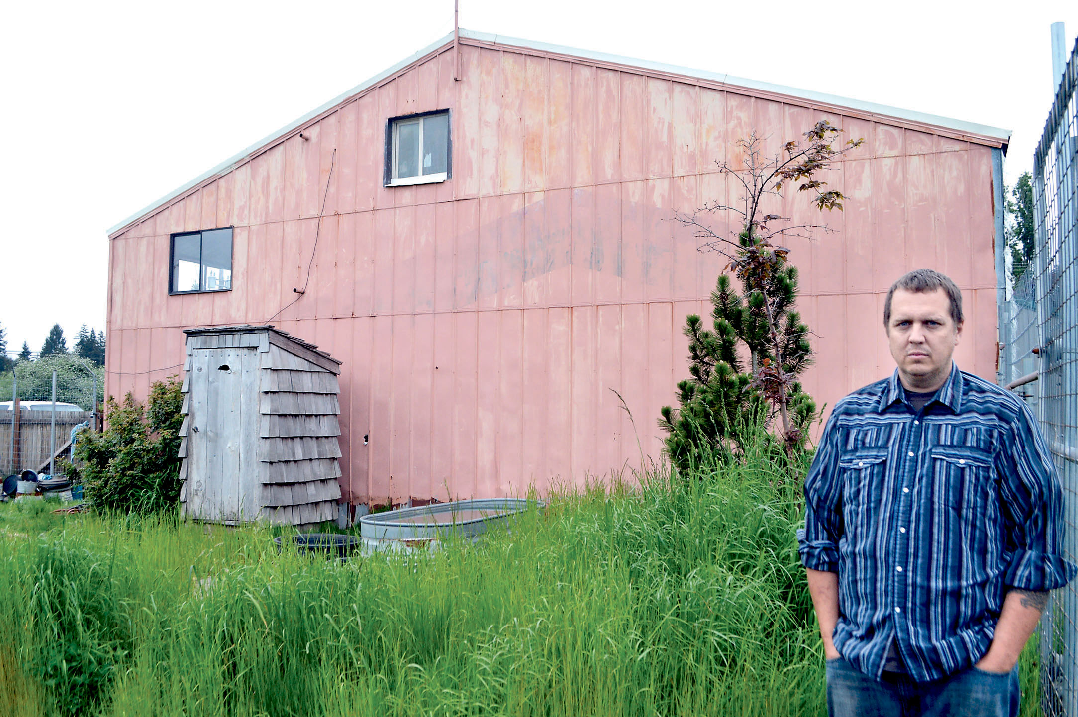 Steve Markwell stands in front of the Forks warehouse in which he once housed 124 dogs as the Olympic Animal Sanctuary.  Photo by Joe Smillie/Peninsula Daily News. [Copyright &Copy; 2014