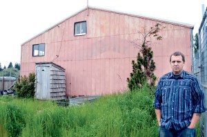 Steve Markwell stands in front of the Forks warehouse in which he once housed 124 dogs as the Olympic Animal Sanctuary.  Photo by Joe Smillie/Peninsula Daily News. [Copyright &Copy; 2014