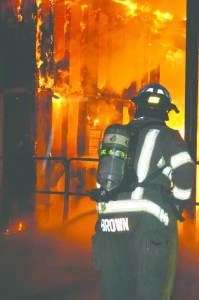A firefighter with Clallam County Fire District No. 3 battles a blaze in a building at Blue Mountain Transfer Station in Port Angeles in November.  Patrick Young/Clallam County Fire District No. 3