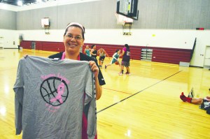 Sharon Kanichy shows off the victory shirt awarded to winners at the fifth annual Team Lynn 3-on-3 basketball tournament held in honor of Kanichys mother