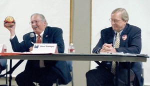 State representative candidate Thomas Greisamer uses a toy ladybug as a metaphor for how he intends to clean up Olympia if elected as incumbent state Rep. Steve Tharinger looks on during a Clallam County League of Women Voters forum Wednesday in Port Angeles.  Rob Ollikainen/Peninsula Daily News