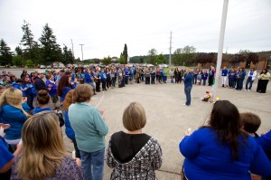 About 130 people gather around the flagpole at Chimacum High School on Saturday for a candlelight vigil in memory of Lindsey Mustread