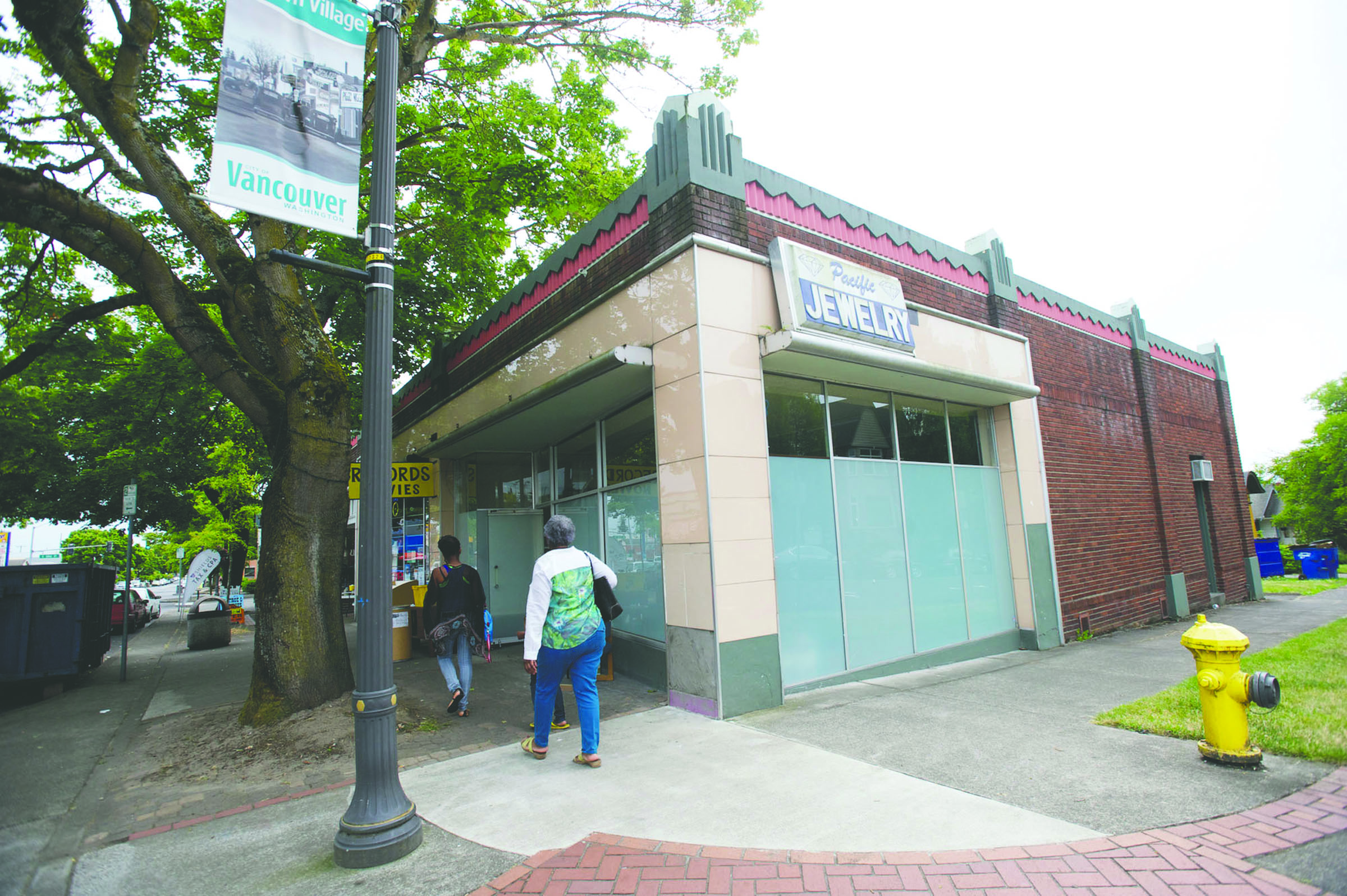 People walk past the building housing Main Street Marijuana in Vancouver