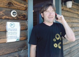 Greg Brotherton talks to a supplier in preparation for opening the North Olympic Peninsula's first recreational pot store Saturday. Charlie Bermant/Peninsula Daily News