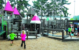 Children play at the Dream Playground at Erickson Playfield in Port Angeles on Tuesday. Keith Thorpe/Peninsula Daily News