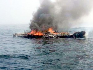 The 25-foot pleasure craft Dawn Trader burns to the waterline just before it exploded in two and sank in the Strait of Juan de Fuca about 4 miles north of Neah Bay. —U.S. Coast Guard photo