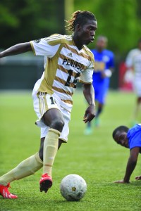 Peninsula College's Ashkanov Apollon dribbles up the pitch during a friendly match against Edmonds. Apollon