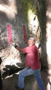 Steve Johnson scrubs a graffito from Tamanowas Rock during a seven-hour cleanup session Sept. 11.  Bill Laubner