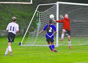 Port Townsend goalkeeper Malia Henderson deflects a shot on goal by Sequim's Nicole Anders (2) during an Olympic League game played at Memorial Field. Steve Mullensky/for Peninsula Daily News