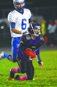 Sequims Matthew Sierra (28) looks up after making a catch in front of the defense of Olympics Joel Gesicki. Photo -- Keith Thorpe/Peninsula Daily News