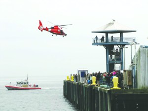 The U.S. Coast Guard performs rescue demonstrations for visitors at the Dungeness Crab & Seafood Festival on Sunday off City Pier in Port Angeles. Arwyn Rice/Peninsula Daily News