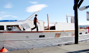 A Vessel Assist crew member walks on the deck of the Lady A at John Wayne Marina in Sequim on Sunday. Two crews prepared the hull for towing to Port Angeles