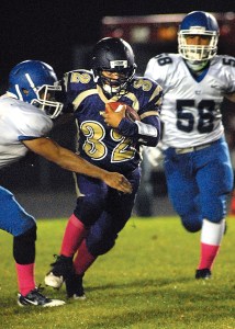 Sequim's Arnold Black (32) tries to elude Olympic's Logan Madison