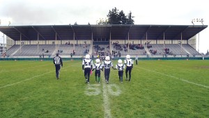 Youth football players walk to midfield for the coin toss at Port Angeles Civic Field on Saturday. Photo by Keith Thorpe/Peninsula Daily News