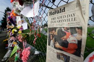 An edition of The Daily Herald of Everett with the headline Dreaded Day in Marysville is shown Monday as part of a growing memorial on a fence around Marysville Pilchuck High School. Photo by Ted S. Warren/The Associated Press