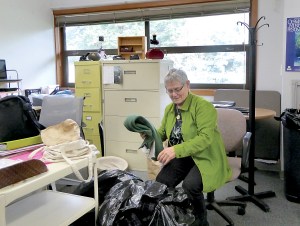 Working Image office manager Liz Berman sorts through some of the donations collected for use by low income women seeking to enter the workforce.  Charlie Bermant/Peninsula Daily News