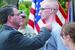 Pfc. Jeremiah Wright of Port Angeles formally receives the Purple Heart award and a combat action badge from Deputy Defense Secretary Ashton B. Carter at Brooke Army Medical Center in San Antonio