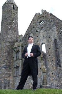Anthony Kearns stands at Ireland's Rock of Cashel.