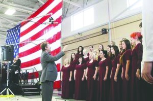 John Lorentzen directs Sequim High School singers in the national anthem during 2013s Veterans Day ceremony at Coast Guard Air Station/Sector Field Office Port Angeles.  Dave Logan/for Peninsula Daily News