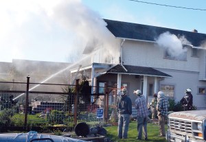 Firefighters were able to contain a blaze on Quincy Street in Port Townsend in about 20 minutes Thursday. No one was injured as the homeowners were out of town.  Charlie Bermant/Peninsula Daily News