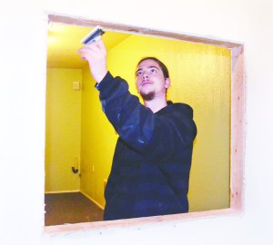 Gracen Hook prepares the service window in a medical pot dispensary he is opening in Port Townsend within the next few weeks. Hook