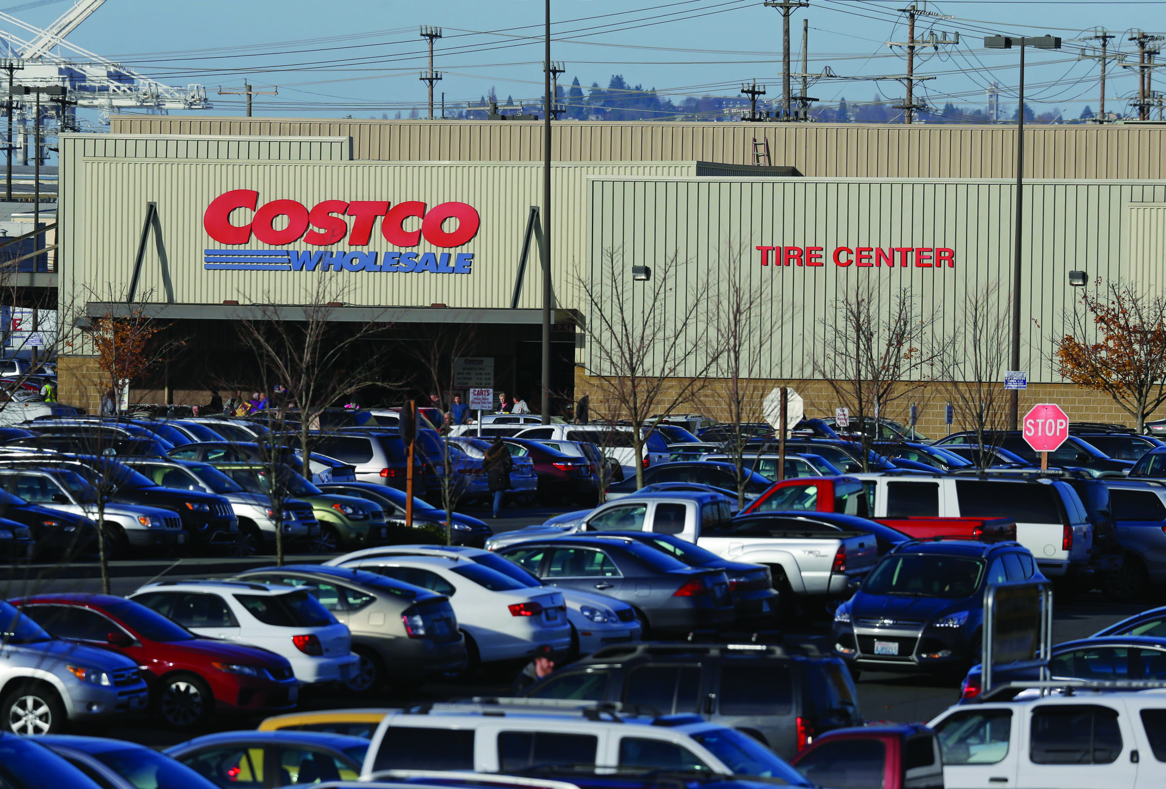 Cars fill the parking lot of a Costco store in Seattle on Tuesday. Health authorities said chicken salad from Costco has been linked to at least one case of E. coli in Washington state.  The Associated Press