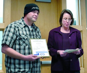 Josh Graham receives an award from Clallam Transit General Manager Wendy Clark-Getzin for coming to the aid of a transit driver who was assaulted Oct. 12. — Rob Ollikainen/Peninsula Daily News
