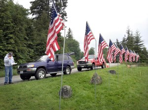 Rotarian John Ericson with American flags placed by the East Jefferson Rotary Club at The Inn at Port Ludlow Resort for Veterans Day. The theft of 13 of the flags placed by the club could have an impact on the number of scholarships the group can award. East Jefferson Rotary Club