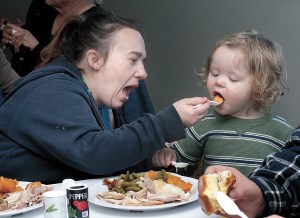 Crystal Holmberg of Port Angeles feeds yams to her son