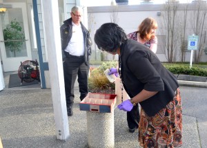 Employees of the Port Townsend Kitsap Credit Union branch remove cash from a tray following Tuesdays incident.  -- Photo by Bill Beezley/East Jefferson Fire-Rescue