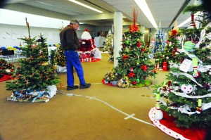 Don Grafstrom of Forks looks over the Christmas trees on display during the 2011 Festival of Trees in Forks. Lonnie Archibald/for Peninsula Daily News