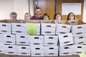 Clallam County Literacy Council volunteers prepare to fill boxes with books for delivery to participating sites. From left are JoAnn Thomson