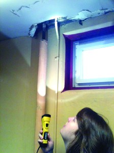 Pool employee Sarah Winslow shines some light on a portion of the ceiling in the womens changing room at Mountain View Commons. The city of Port Townsend is looking for ways to pay for repairs of the building