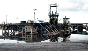A log debarker sits idle at the Port of Port Angeles log yard next to the former Peninsula Plywood site on the Port Angeles waterfront.  Keith Thorpe/Peninsula Daily News