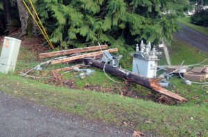 A section of a power pole that was knocked down by wind and caused a power outage on Marrowstone Island is still in a ditch waiting for cleanup by the Jefferson County Public Utility District. Photo by Charlie Bermant/Peninsula Daily News