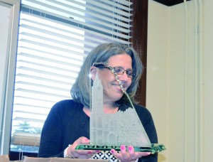 Elections Supervisor Karen Cartmel holds a plaque depicting the Jefferson County Courthouse at her retirement party.  Photo by Charlie Bermant/Peninsula Daily News