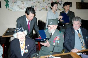 Republic of Korea Consul General Moon Duk-ho presents his countrys Ambassador for Peace medal to Korean War veteran Don Roberts at a luncheon Monday. At left is former Army nurse Mary Reid
