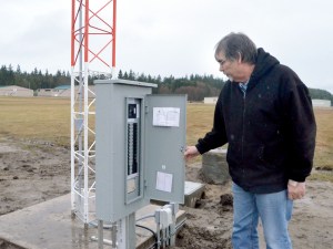 Volunteer Bill Putney checks the circuits on the newly installed AWOS tower at Jefferson County International Airport in Port Townsend. When completed in early 2015