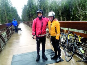 Garland Frankfurth and Bob Anundson were among the first bicyclists to cross the newly opened trestle Thursday. A bystander helped the two remove a fallen tree from the pathway.  Cheryl Garland