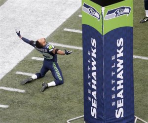 Seattle Seahawks free safety Earl Thomas kneels on the CenturyLink Field turf. Photo by The Associated Press