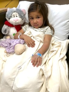 Five-year-old Hartlyn Flores receives an infusion in October. She has a reputation for approaching medical appointments armed with high heels