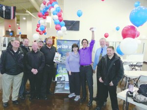 Employees of Price Ford Lincoln of Port Angeles congratulate Sherry Lawrence of Port Angeles