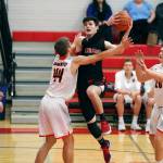 Steve Mullensky/for Peninsula Daily News Redhawk Jackson Foster watches as teammate Noa Montoya goes up for a basket against Blaine Borerites Niko Friker and Hudson Reid in a Crush in the Slush game on Friday at Port Townsend High School.