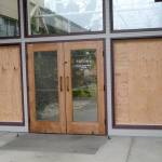 The damaged north entrance to Port Angeles City Hall is shown Saturday. Police said Wesley Alcorn threw landscaping rocks into the windows. (Rob Ollikainen/Peninsula Daily News)