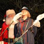 Port Townsend Mayor Deborah Stinson welcomes the crowd Saturday with Santa Claus in the background. (Mark Krulish/for Peninsula Daily News)