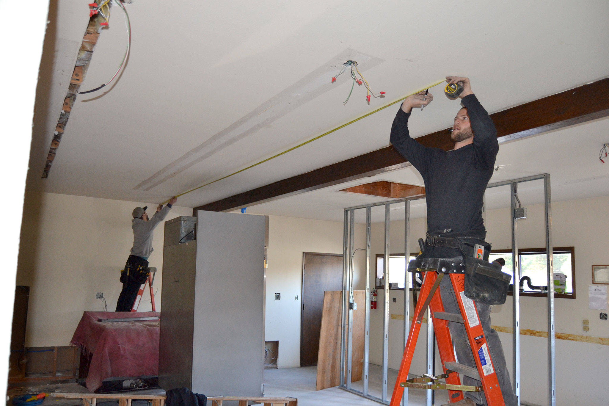 <strong>Matthew Nash</strong>/Olympic Peninsula News Group                                Tyler Philp, left, and Tyler Wickersham with North Peninsula Electric take measurements for new lighting inside the Guy Cole Convention Centers commercial kitchen.