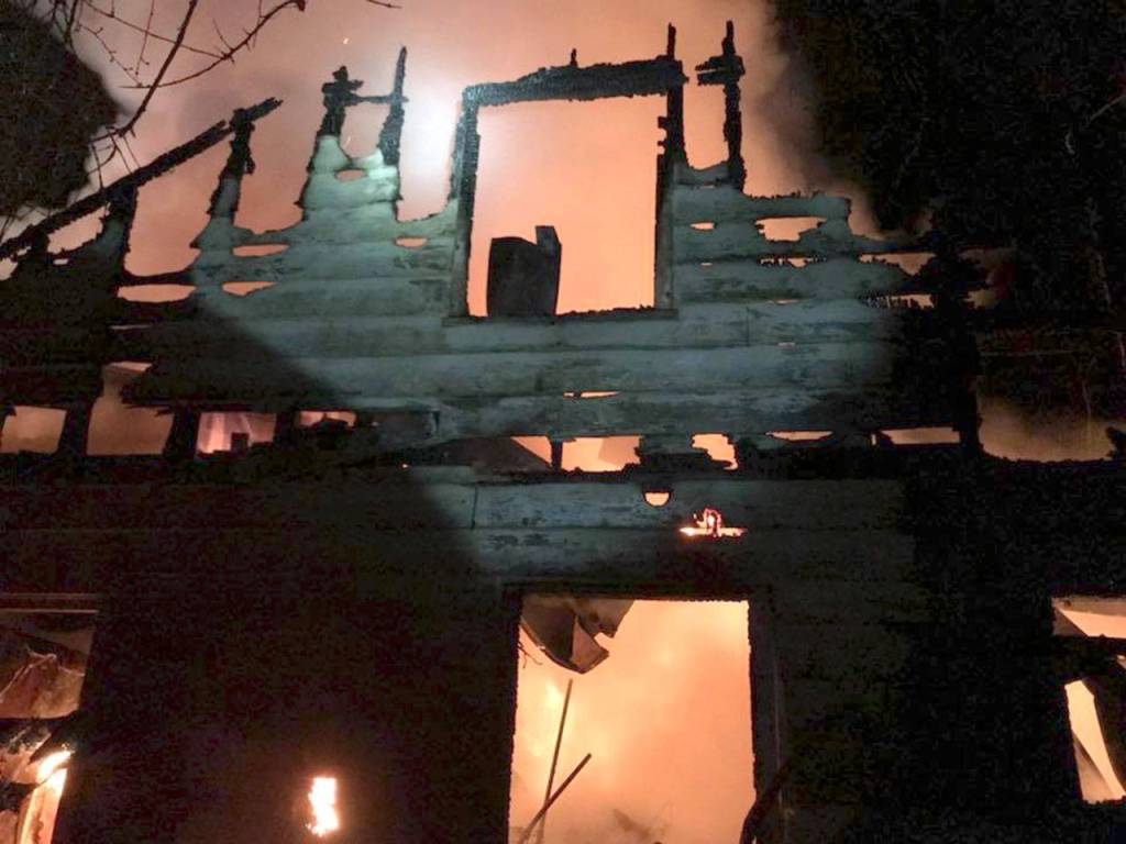 A wall of the home is seen nearly consumed by fire Monday night. (Tye Seeley)