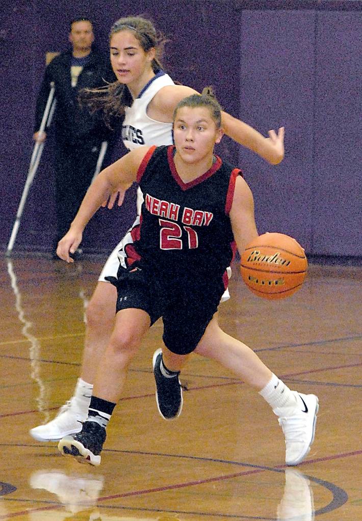 <strong>Keith Thorpe</strong>/Peninsula Daily News                                Neah Bays Gina McCaulley, front, drives down the floor past Sequims Hope Glasser in the fourth quarter Tuesday at Sequim High School.
