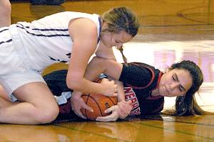 Keith Thorpe/Peninsula Daily News Sequims Bobbi Sparks, top, and Neah Bays Courtney Swan battle for a loose ball in the closing minutes of Tuesday nights matchup at Sequim High School.